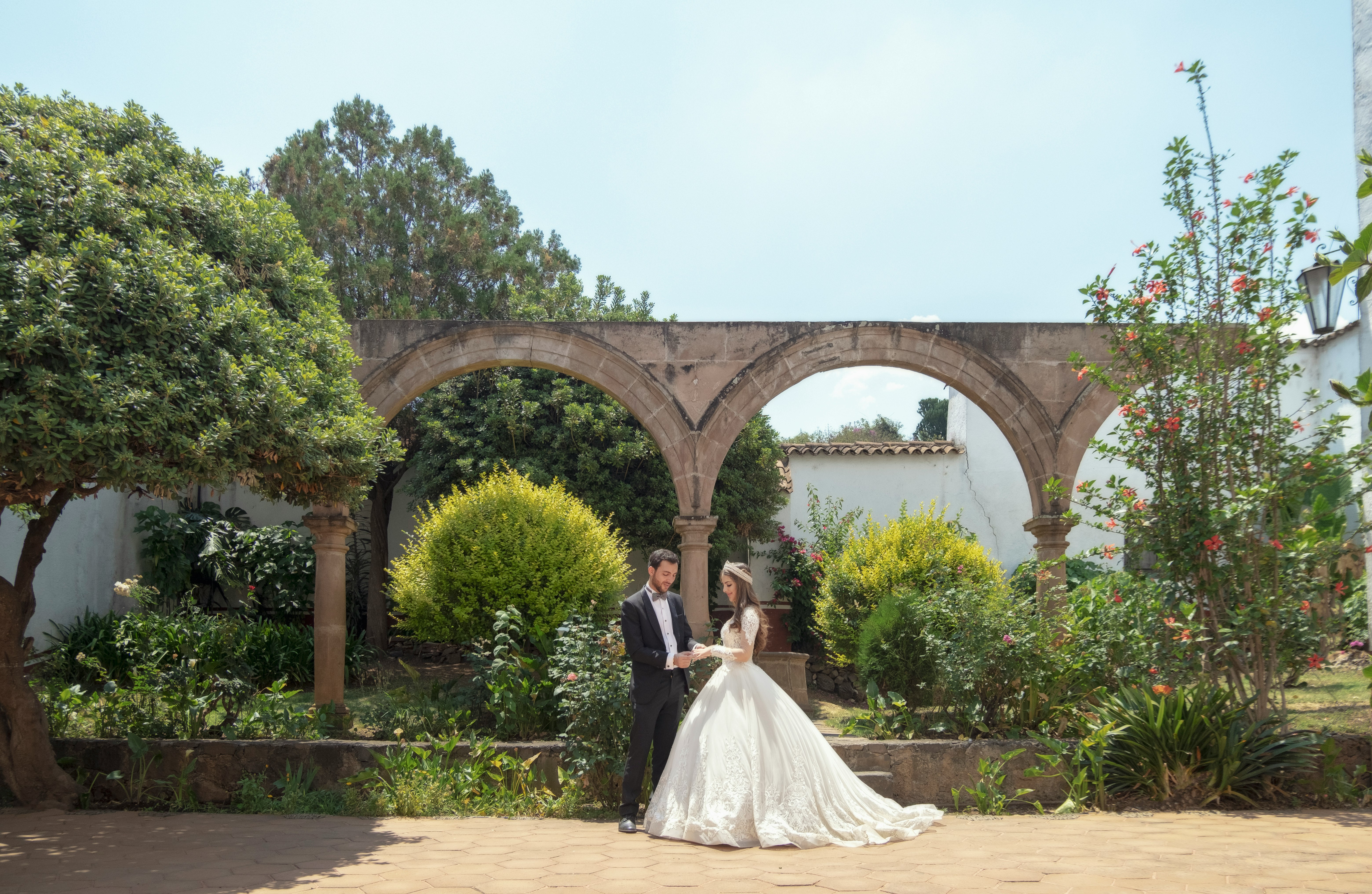 bride and groom standing on brown concrete floor during daytime